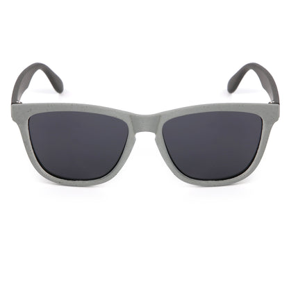 Sunglasses with gray frame and dark lenses on a white background